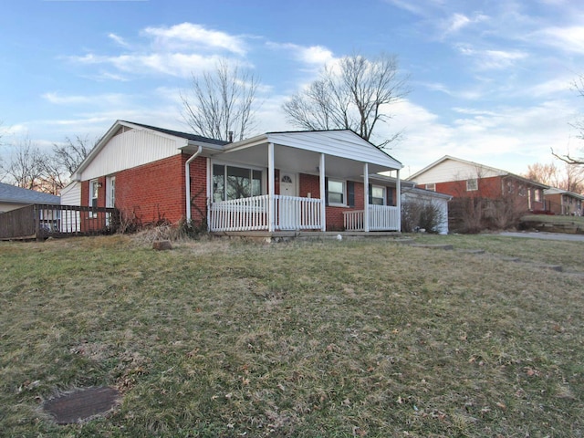 view of front facade featuring a porch, a front lawn, and brick siding