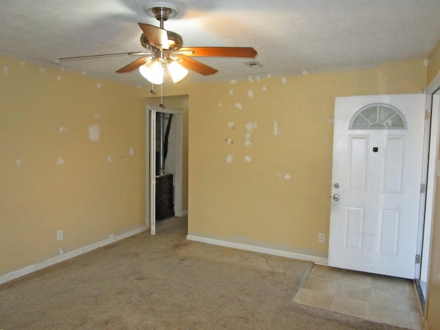 interior space with visible vents, ceiling fan, and baseboards