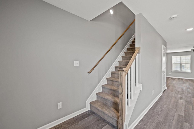 stairway featuring recessed lighting, baseboards, and wood finished floors