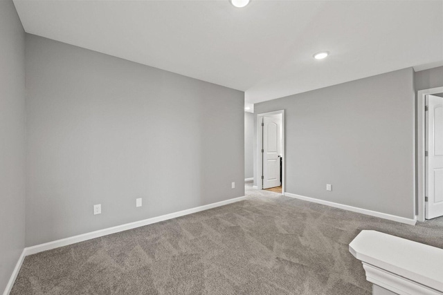 unfurnished room featuring carpet floors, baseboards, and recessed lighting