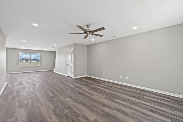 empty room with ceiling fan, recessed lighting, visible vents, baseboards, and dark wood finished floors