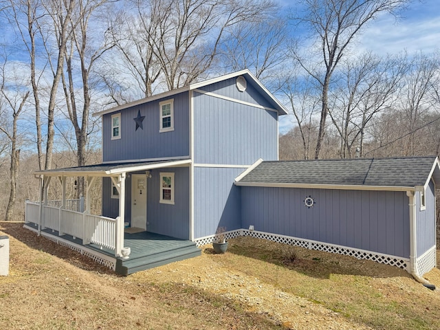 view of front facade featuring a porch and roof with shingles