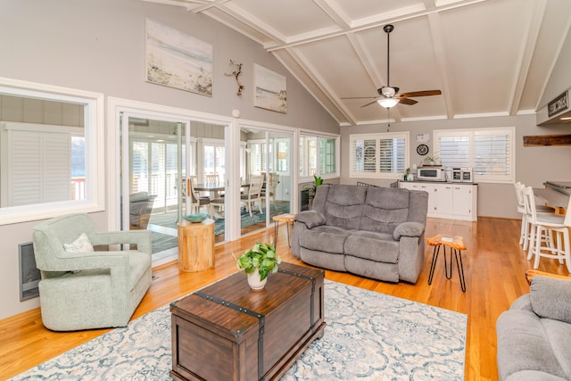 living area featuring a healthy amount of sunlight, light wood-style flooring, and ceiling fan