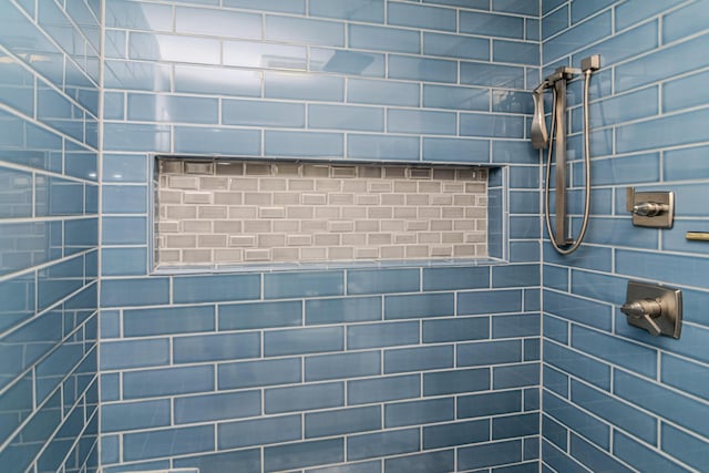 bathroom with a tile shower