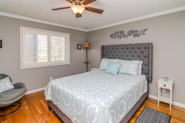 bedroom with crown molding, wood finished floors, baseboards, and ceiling fan