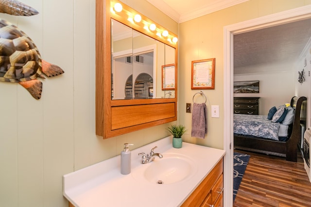 bathroom featuring vanity, wood finished floors, and crown molding