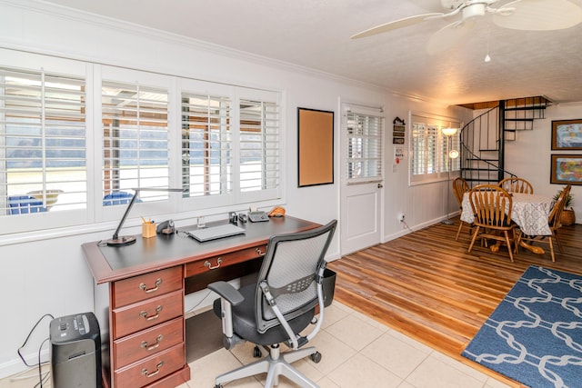 office featuring a wealth of natural light, light wood-type flooring, ceiling fan, and crown molding