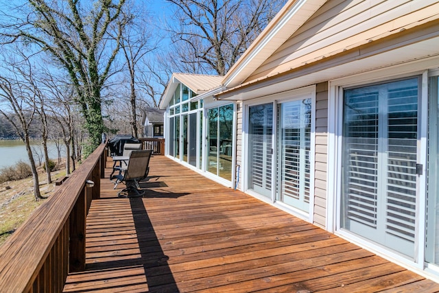 wooden terrace featuring a water view