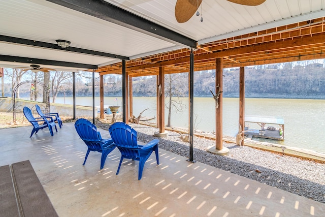 exterior space featuring beamed ceiling, a ceiling fan, and a water view