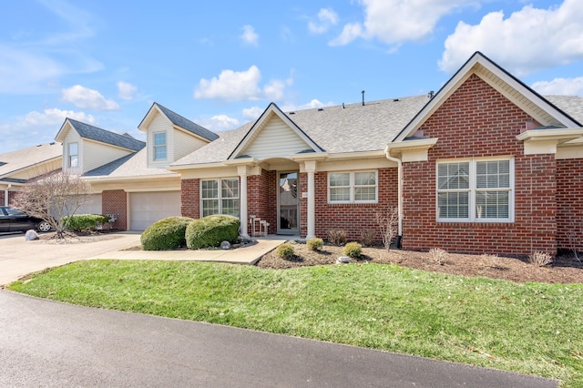 view of front of house featuring a garage, brick siding, a shingled roof, concrete driveway, and a front yard