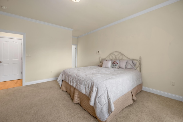 carpeted bedroom featuring baseboards and ornamental molding
