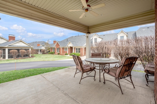 view of patio / terrace with a residential view, outdoor dining area, and a ceiling fan