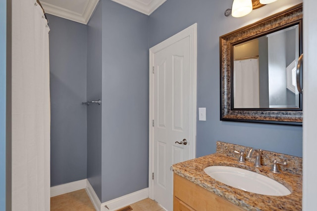 bathroom featuring tile patterned floors, baseboards, crown molding, and vanity