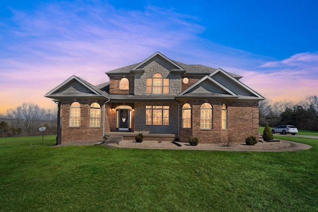 view of front of home with brick siding and a front yard