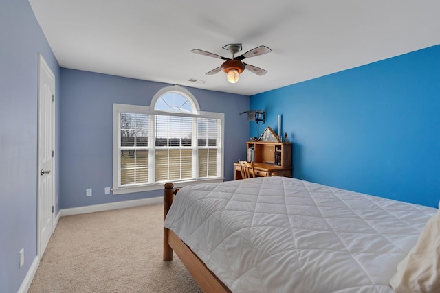 carpeted bedroom featuring visible vents, a ceiling fan, and baseboards