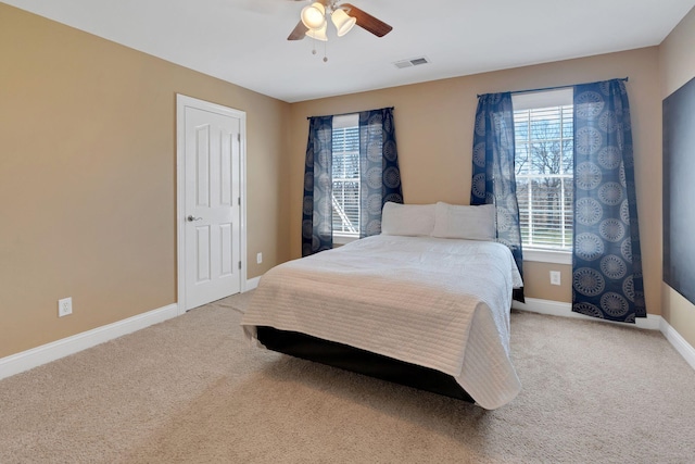 bedroom featuring ceiling fan, carpet, visible vents, and baseboards