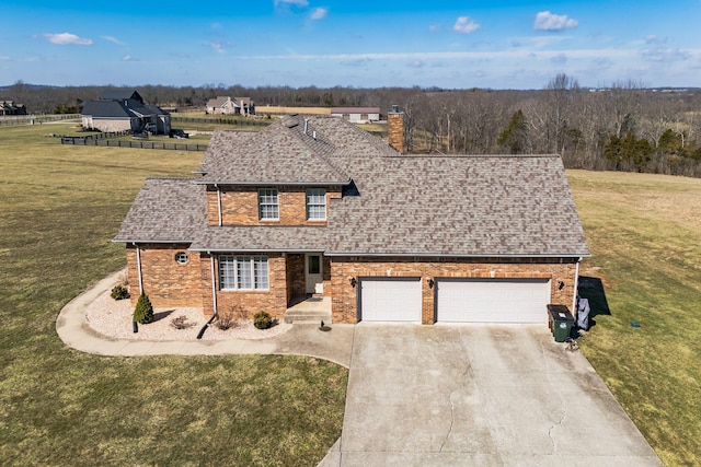 view of front of property with concrete driveway, a chimney, roof with shingles, a front lawn, and brick siding