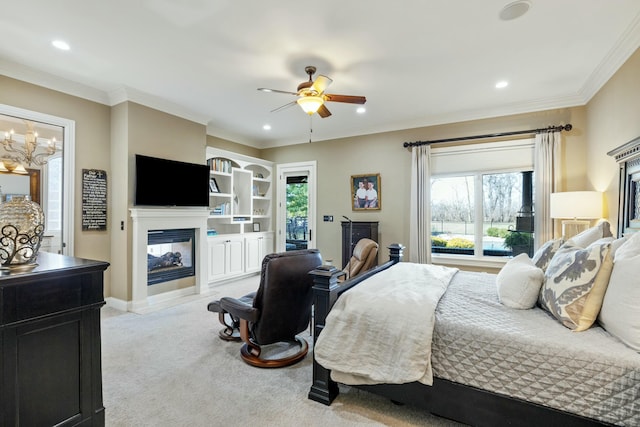 carpeted bedroom with ceiling fan, access to outside, a multi sided fireplace, and ornamental molding