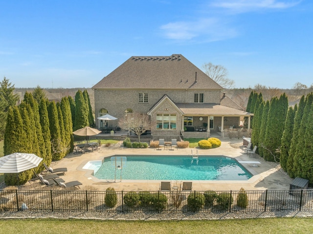 view of swimming pool featuring a patio, fence, and a fenced in pool