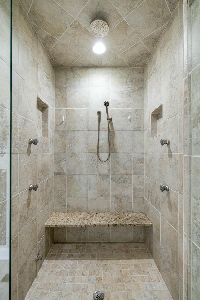 full bathroom with a tile shower