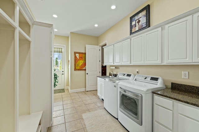 laundry room with baseboards, washing machine and clothes dryer, recessed lighting, cabinet space, and a sink