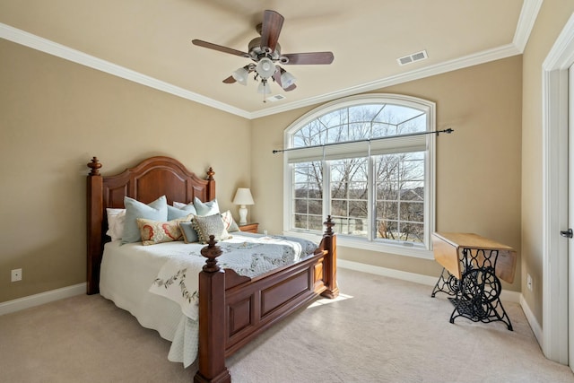 bedroom with visible vents, light carpet, ornamental molding, baseboards, and ceiling fan