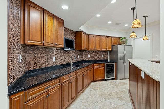 kitchen with tasteful backsplash, wine cooler, brown cabinetry, stainless steel fridge, and a sink