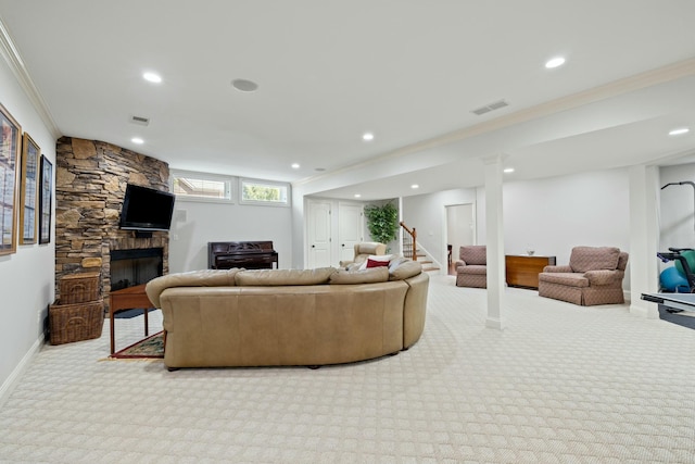 carpeted living room featuring visible vents, a fireplace, crown molding, and baseboards