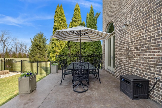 view of patio featuring outdoor dining area and fence