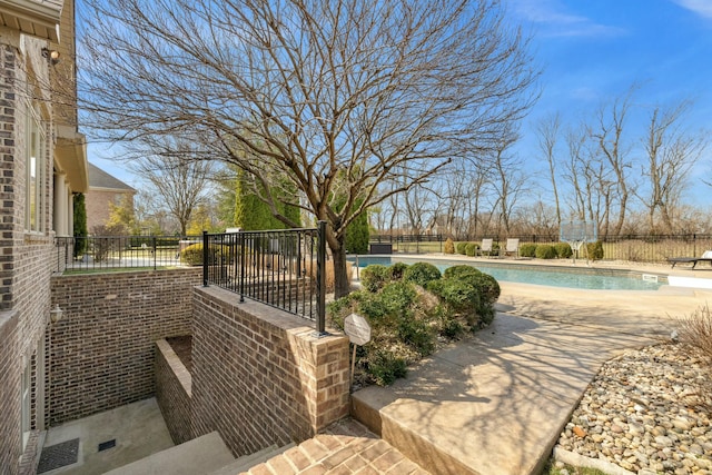 view of patio / terrace featuring a fenced in pool and fence