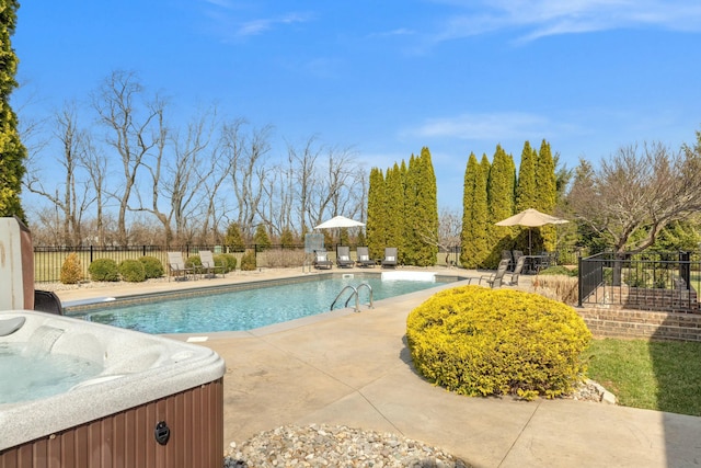 view of pool with a patio area, fence, a fenced in pool, and a hot tub