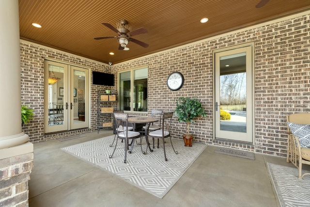 view of patio with outdoor dining area, french doors, and ceiling fan