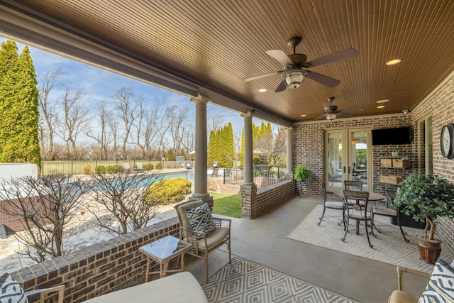 view of patio with a fenced in pool, french doors, a ceiling fan, and fence