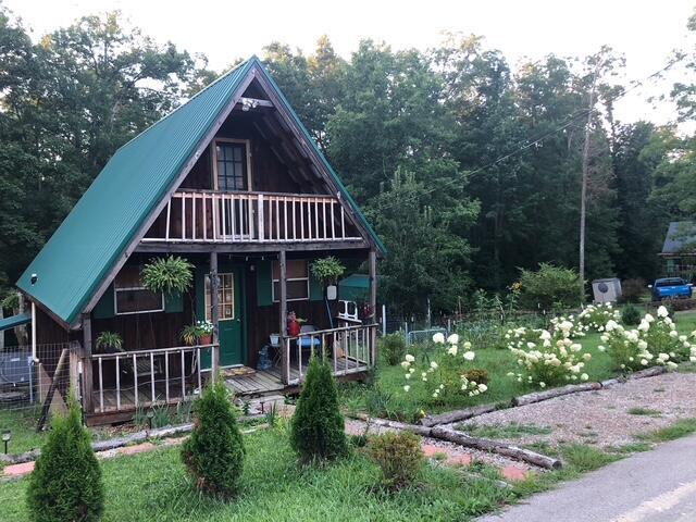 exterior space with metal roof, a porch, and a balcony