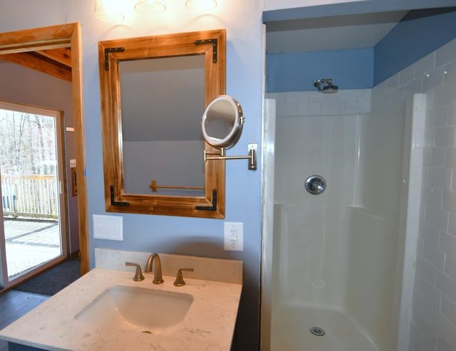 full bathroom featuring a stall shower and vanity