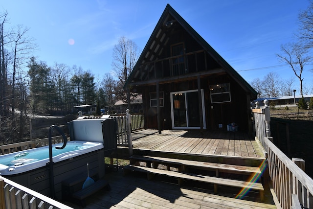 wooden deck featuring a hot tub