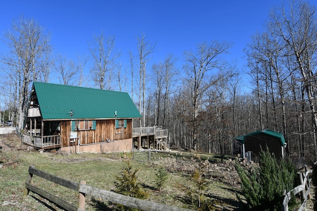 exterior space with metal roof and a deck