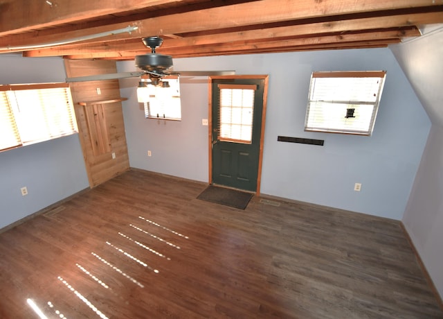 foyer featuring beamed ceiling, wood finished floors, and a healthy amount of sunlight