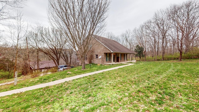 view of front of house featuring a front yard and brick siding