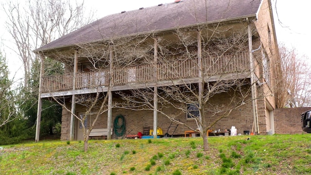 rear view of property featuring brick siding