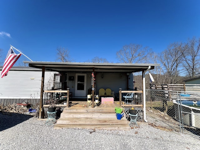 view of front of house with a deck and fence