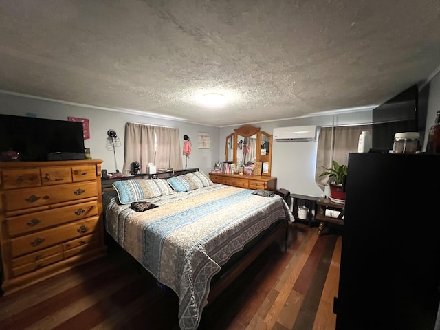 bedroom featuring a textured ceiling, ornamental molding, dark wood-type flooring, and an AC wall unit