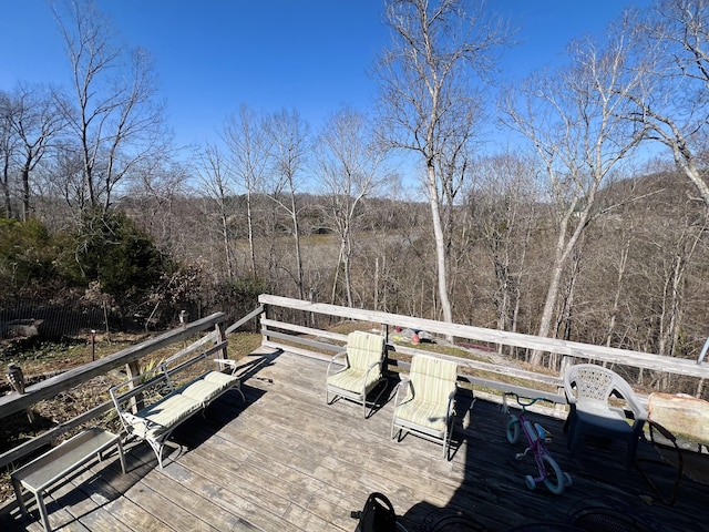 wooden deck featuring a view of trees