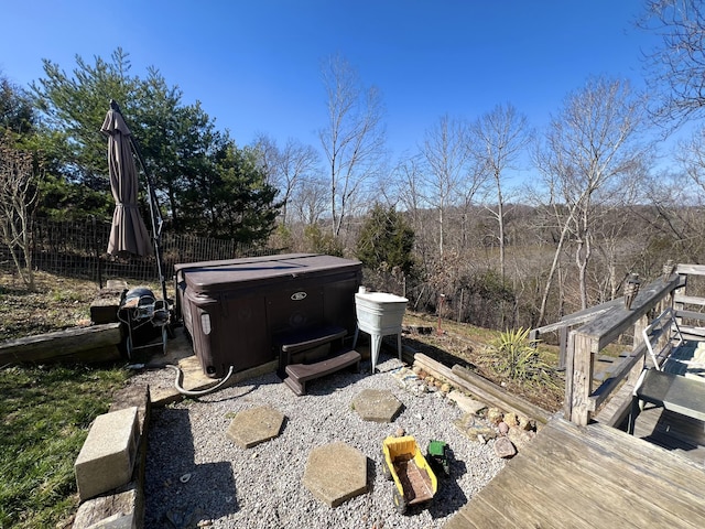 exterior space featuring a hot tub and fence