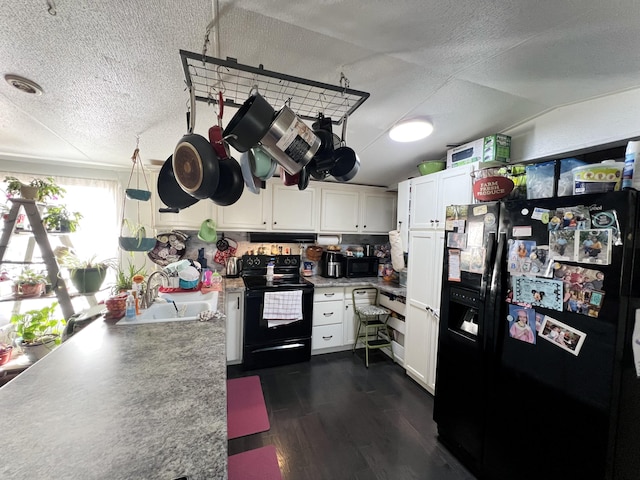 kitchen with dark wood-style flooring, a textured ceiling, black appliances, white cabinetry, and a sink