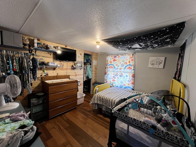 bedroom featuring a textured ceiling and wood finished floors