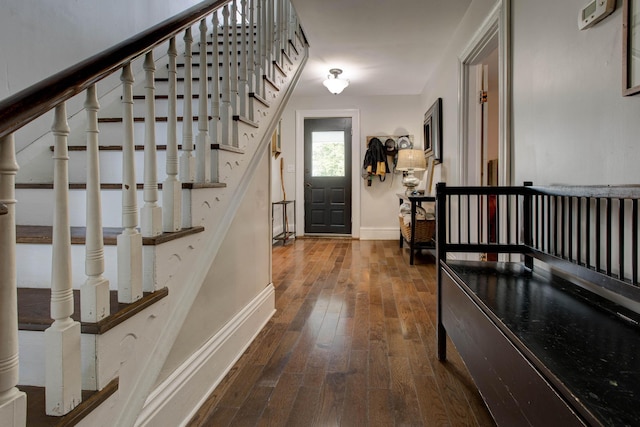 foyer featuring stairs, baseboards, and hardwood / wood-style flooring