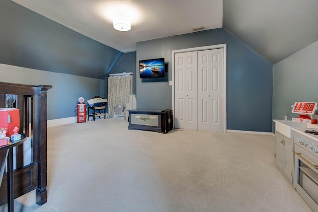 rec room with lofted ceiling, light carpet, and visible vents