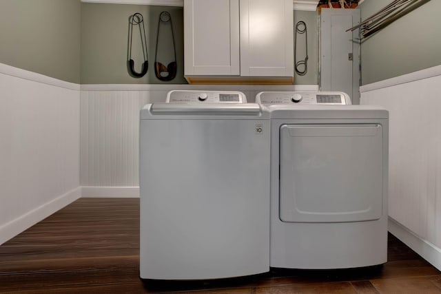 washroom featuring dark wood-style flooring, cabinet space, a wainscoted wall, and separate washer and dryer