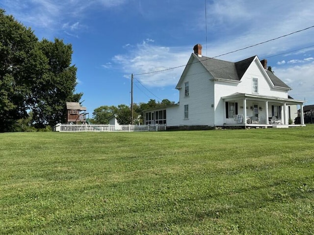 view of property exterior with a lawn and fence